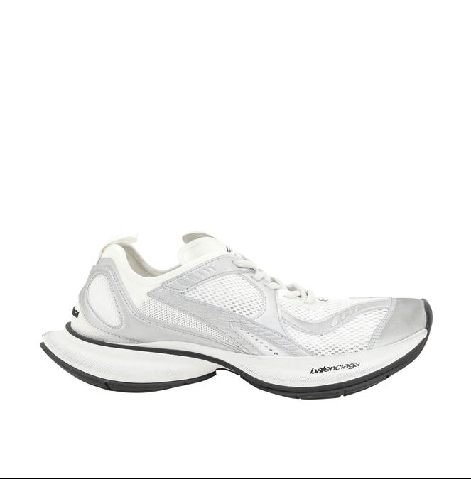 White athletic shoe with black sole on a white background