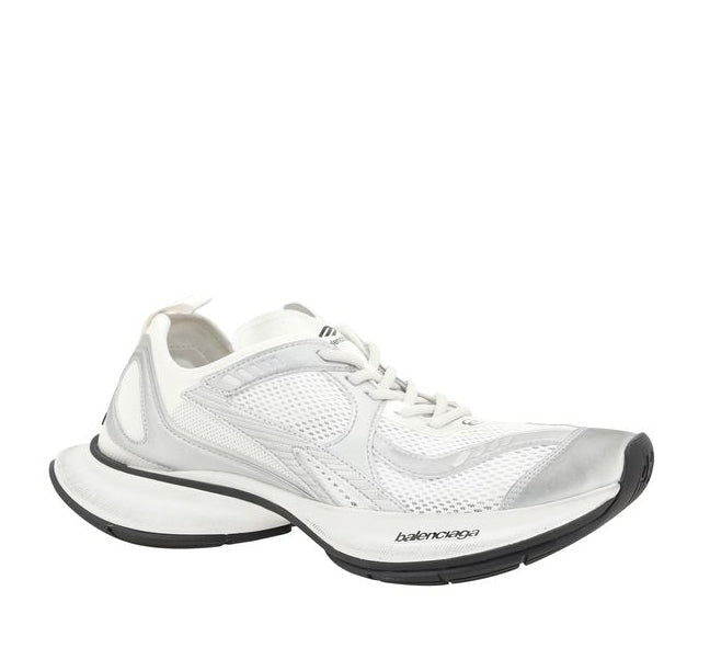 White athletic shoe with black sole on a white background