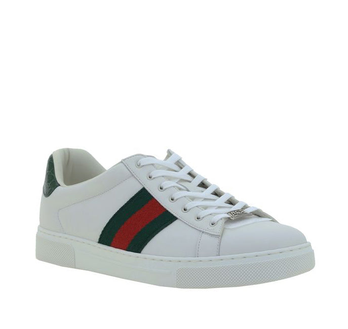 White sneaker with a green and red stripe on a white background