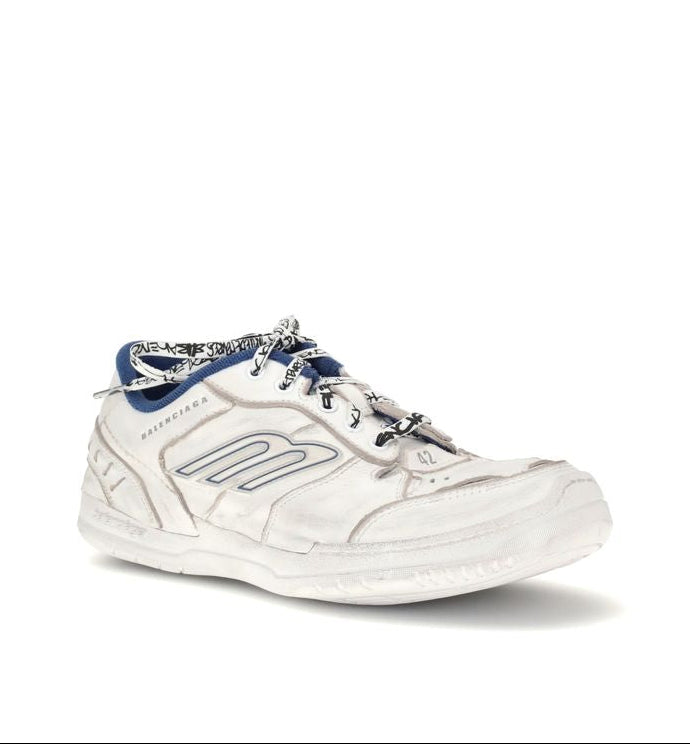 White sneaker with blue accents on a white background